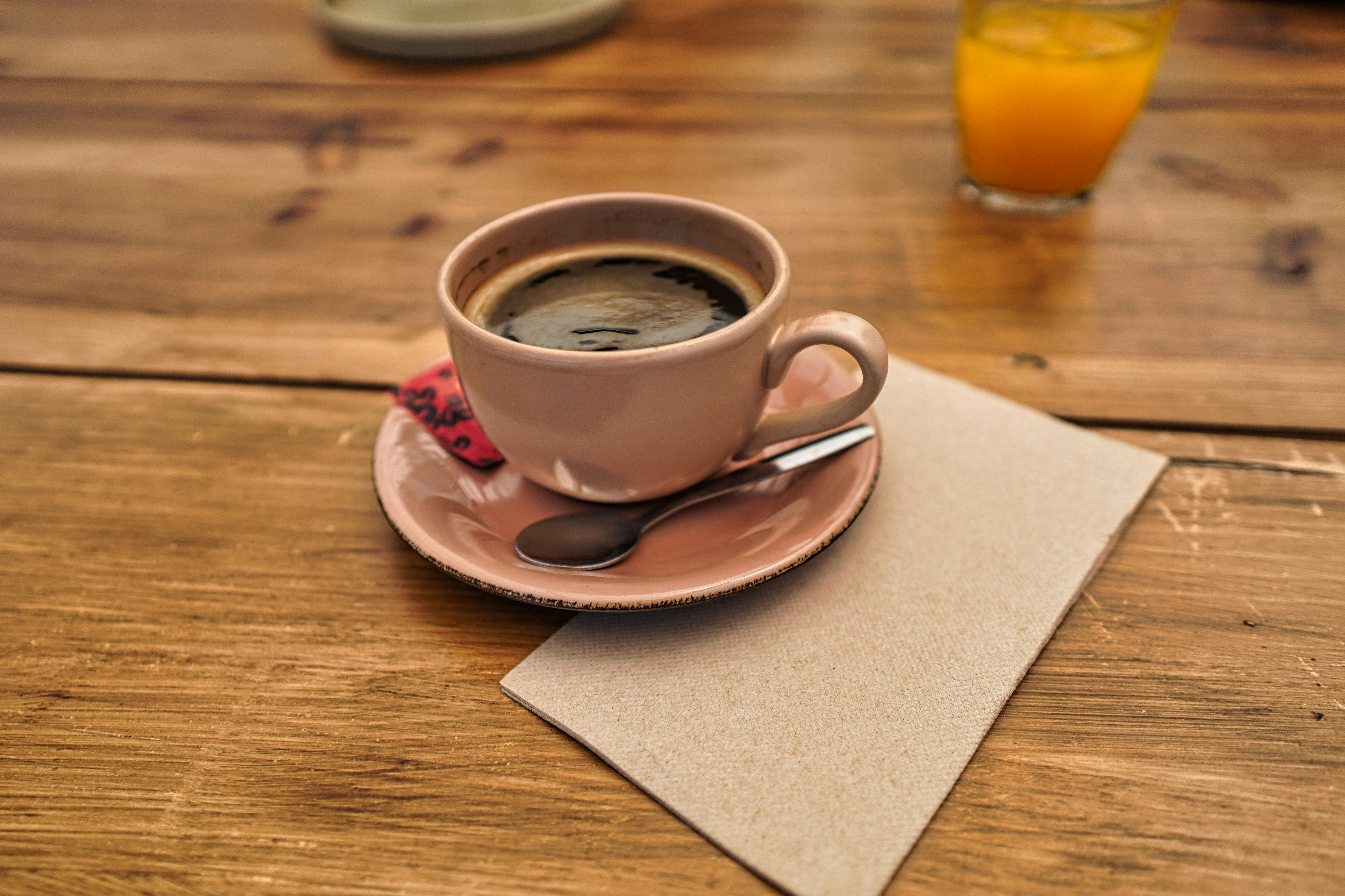 a pink cup filled with black coffee from coffee shop in spinningfields
